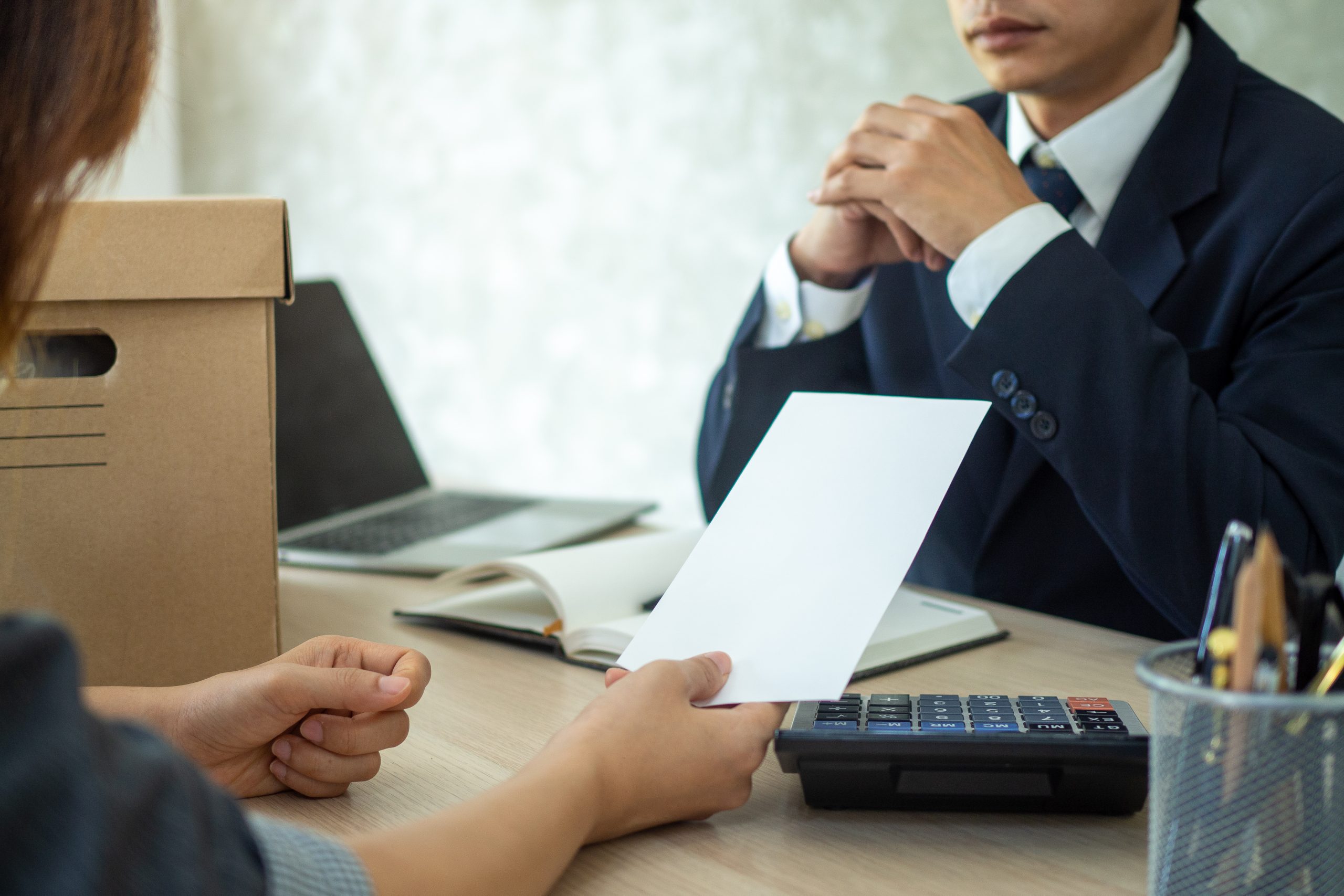 Businesswoman sending a resignation letter to employer boss in order to dismiss contract, changing and resigning from work concept.