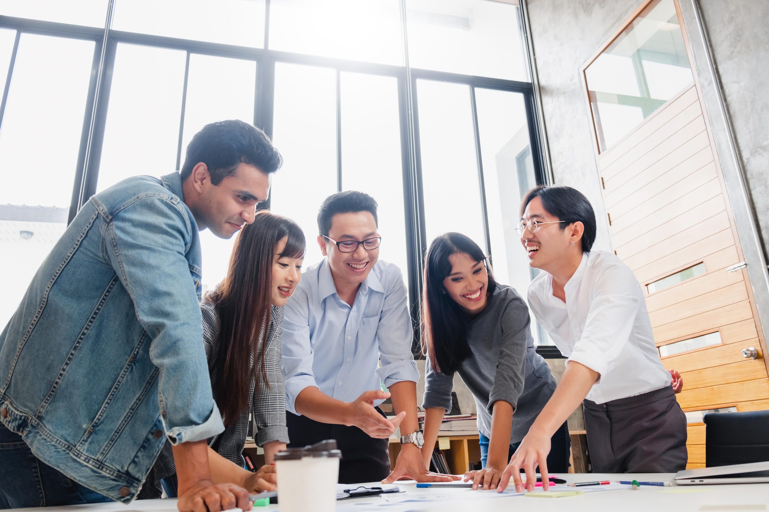 Group of Asian business people and creative designer meeting in office